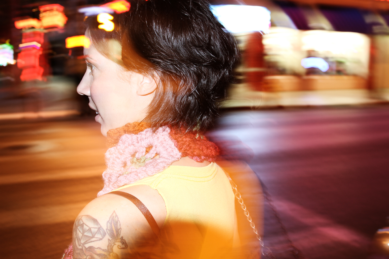 Photograph of woman in city at night time